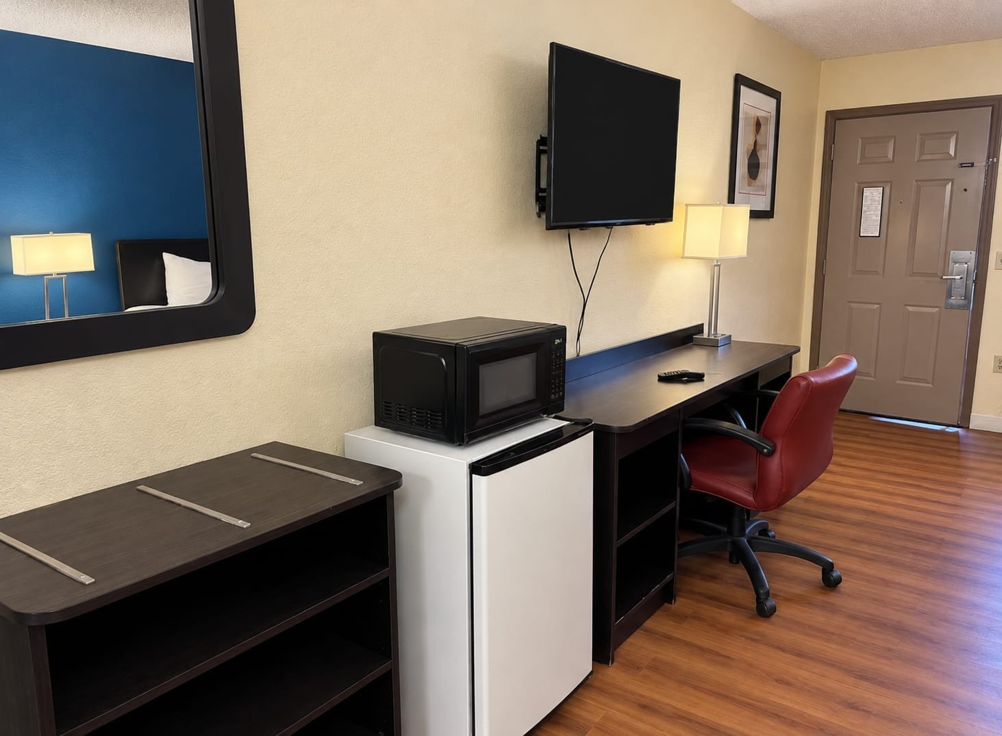 Spacious Mountain Inn room with work desk, flat-screen TV, mini-fridge and microwave